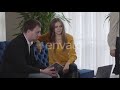 Positive Caucasian Man And Woman Sitting On Couch And Talking As Unrecognizable CEO Walking At T