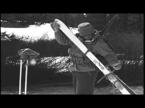 A skier removes the skis and fastens them with a strap to carry them conveniently...HD Stock Footage