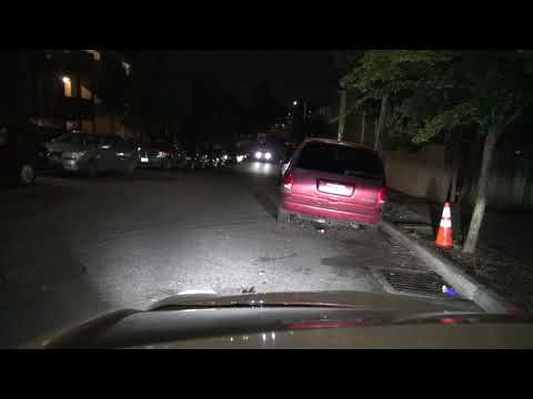 cop trys to ketch man throwing bottles at cars with lights on