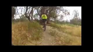 Some guys ride down Olmsted Creek Trail and continue along the outside of Malaga Dunes.