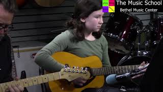 Beatrice plays Jewel-Eyed Judy on acoustic guitar