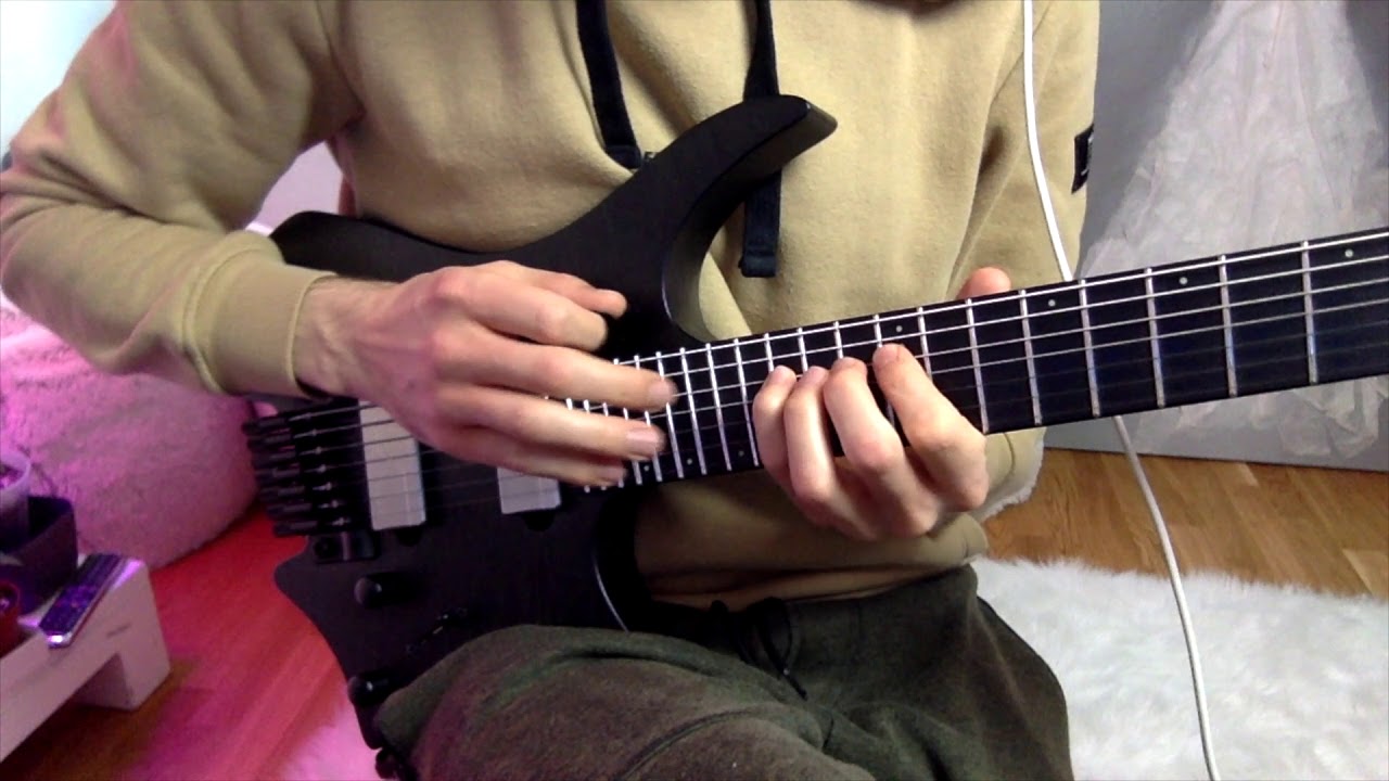 Hands tapping an Am7 arpeggio lick on the electric guitar fretboard