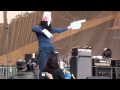 Buckethead playing with nunchucks and doing the robot on stage