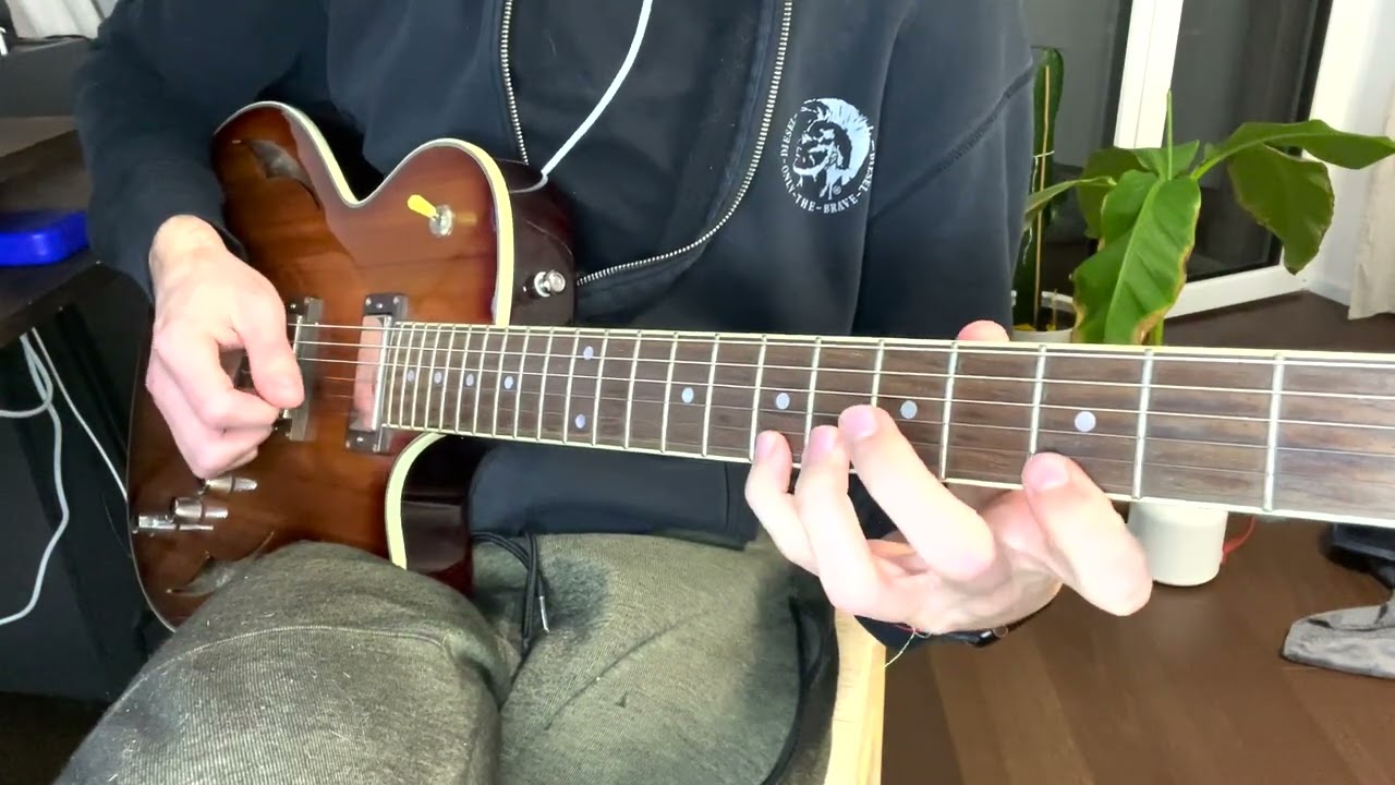 Guitarist demonstrating a dominant 7b5 arpeggio voice leading exercise on the fretboard
