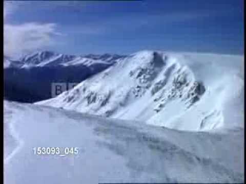 Aerial flying over snow mountain ridges