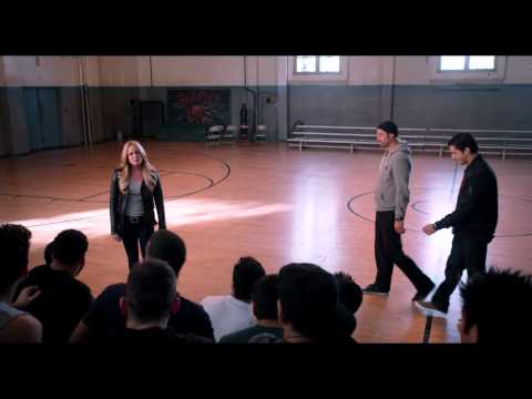 Training montage visual from the Battle of the Year trailer: coach addressing crew in a warehouse gym