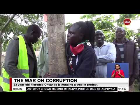 Young activist hugging a tree to protest corruption