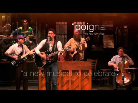 Cast of Once musical playing instruments around a bar set
