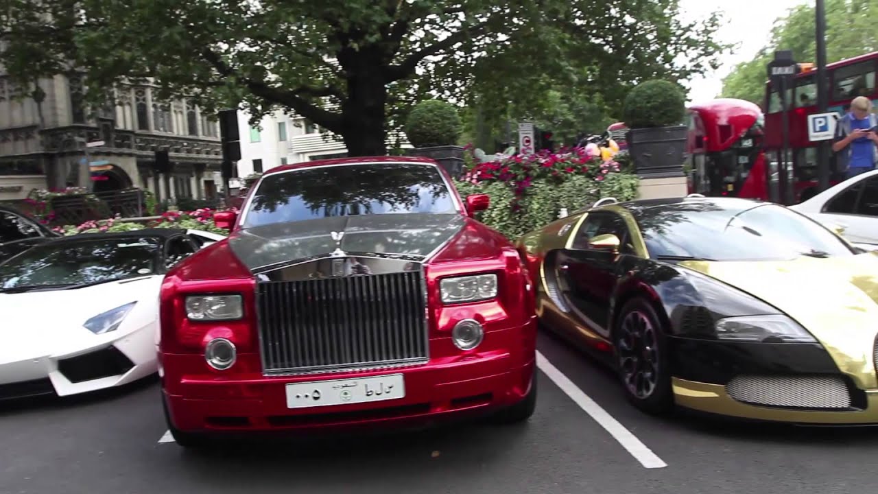 Super cars parked outside Dorchester hotel on a sunny day in London