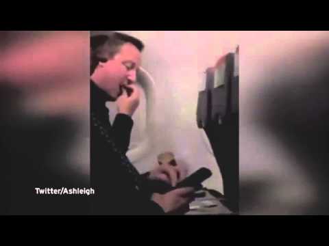 5925 BCG It's not so hot at the top Prime Minister David Cameron tucks into crisps on Easyjet flight