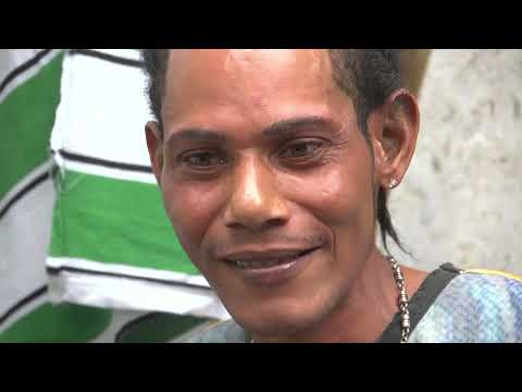 Trailer still: Bunny Wailer greeting Snoop Lion as drummers circle — a scene underscored by roots rhythm