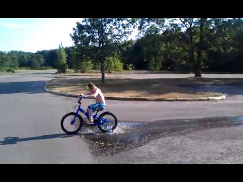 Jameson riding bike in puddle