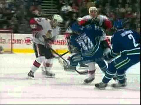 Chris Neil flattens Henrik Sedin