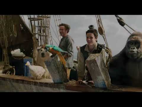 Trailer still: bustling palace courtyard hinting at comic pomp in the score