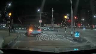 A car and cyclist crossed paths without slowing down, and the cyclist later lost balance and fell.