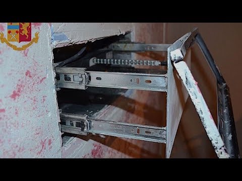 High-tech TV hideaway stuffed with guns, drugs and money