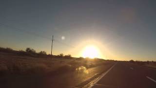 preview picture of video 'Sun rises on Interstate 8 Freeway West driving toward Sentinel, Arizona, GP030057'