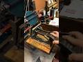 Using A Tabletop Printing Press To Print A Green Image Of A Printing Press
