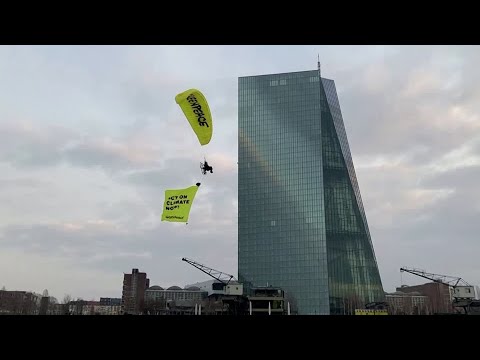 Greenpeace paragliders land on ECB building in protest