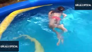 Watch This Fearless Girl Swim with a Huge Python