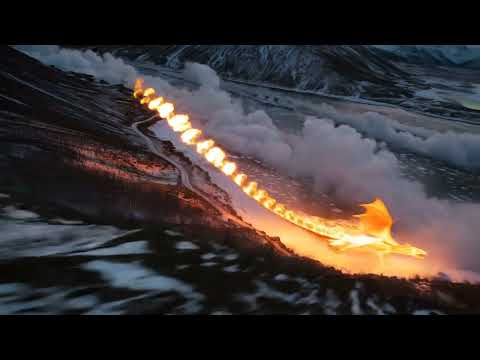 Cinematic drone footage of a dragon made of living fire soaring over a frozen Nordic fjord at twilight. Its wings trail streams of flame that melt the ice below, creating swirling clouds of steam.