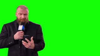 Triple H checks his phone green screen