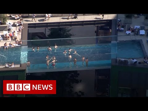 World's first 'floating' pool suspended between London tower blocks - BBC News