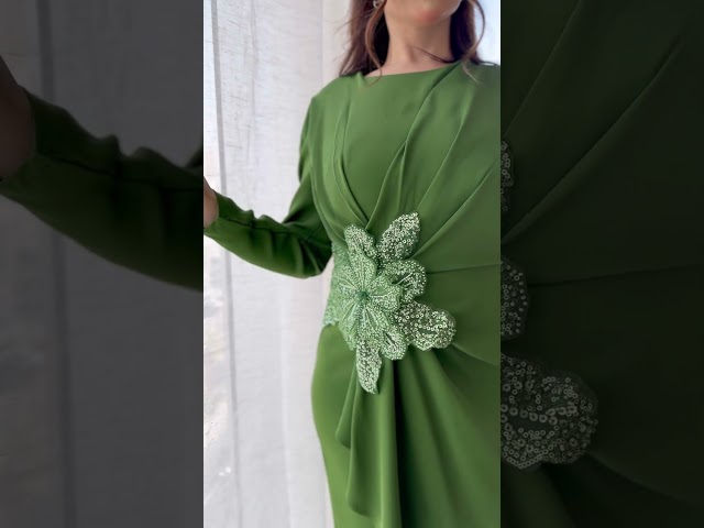 فستان اخضر مزين بوردة بالخصر واكمام طويلة