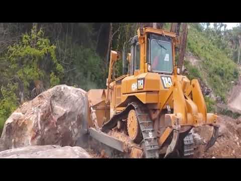 Cat D6T pushes big rocks tracks bulldozer pushing rocks rocks 2023