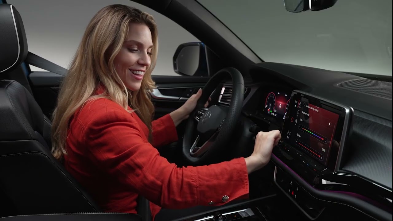 Image of a woman adjusting the lighting inside her Volkswagen vehicle