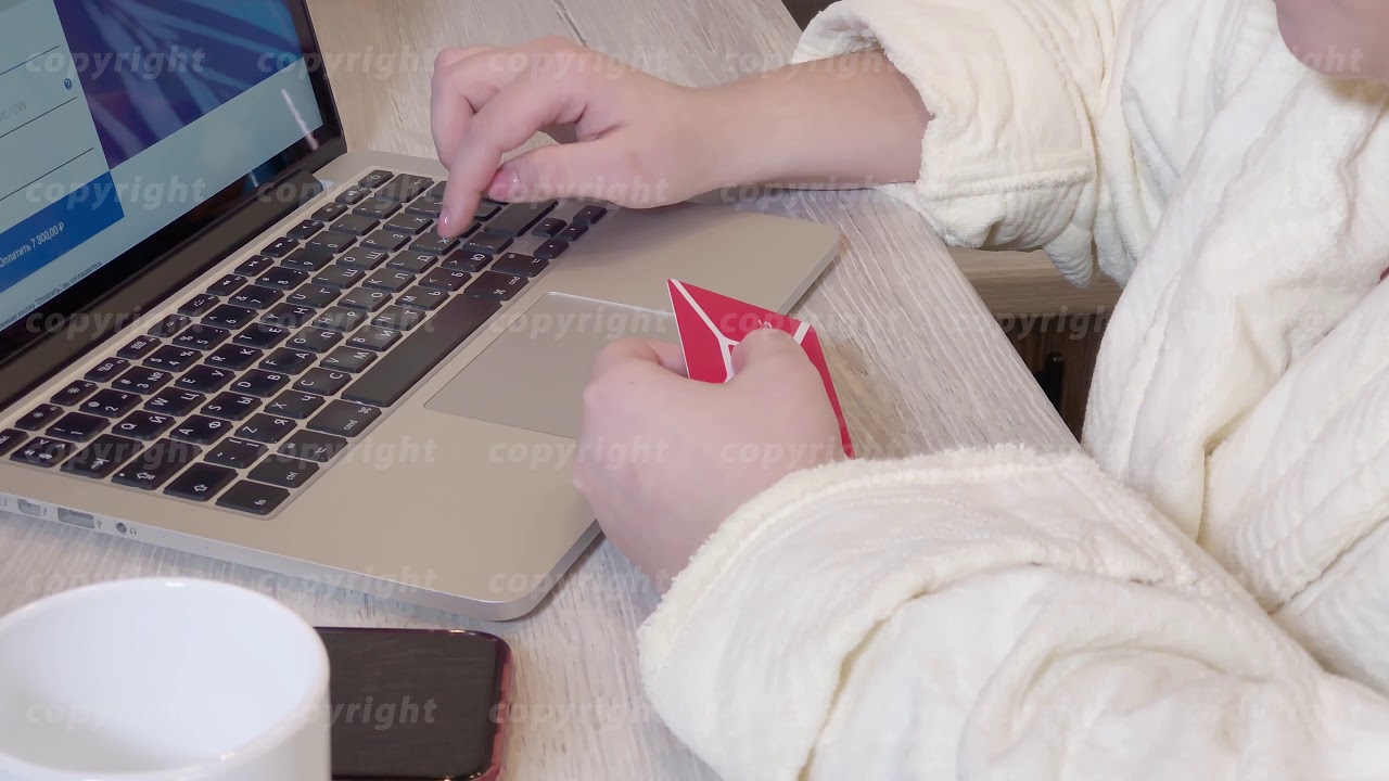 Woman pays for purchase online by credit card using a laptop