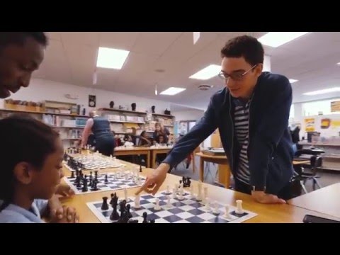 School kids playing simul with Chess Grandmasters