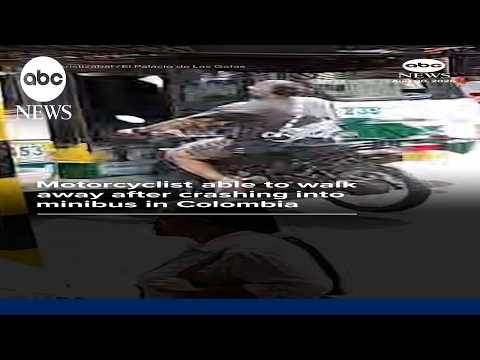 Motorcyclist able to walk away after crashing into minibus in Colombia