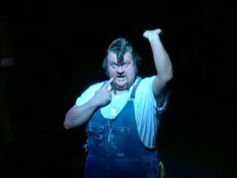 Promo still: Ash raises chainsaw as chorus lines up behind him for the finale