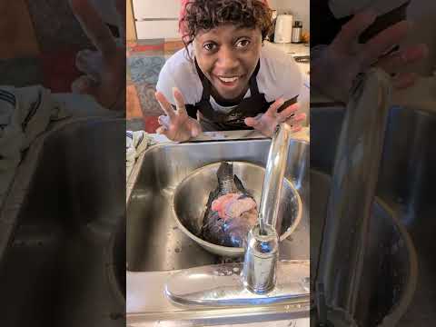 QueenMariana . teaching teenagers how to clean fish and cook it .for bringers