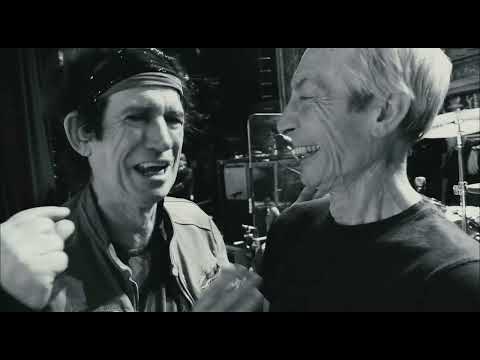 Trailer punch-in: Jagger mid-stride, red lights flaring during “Sympathy for the Devil”