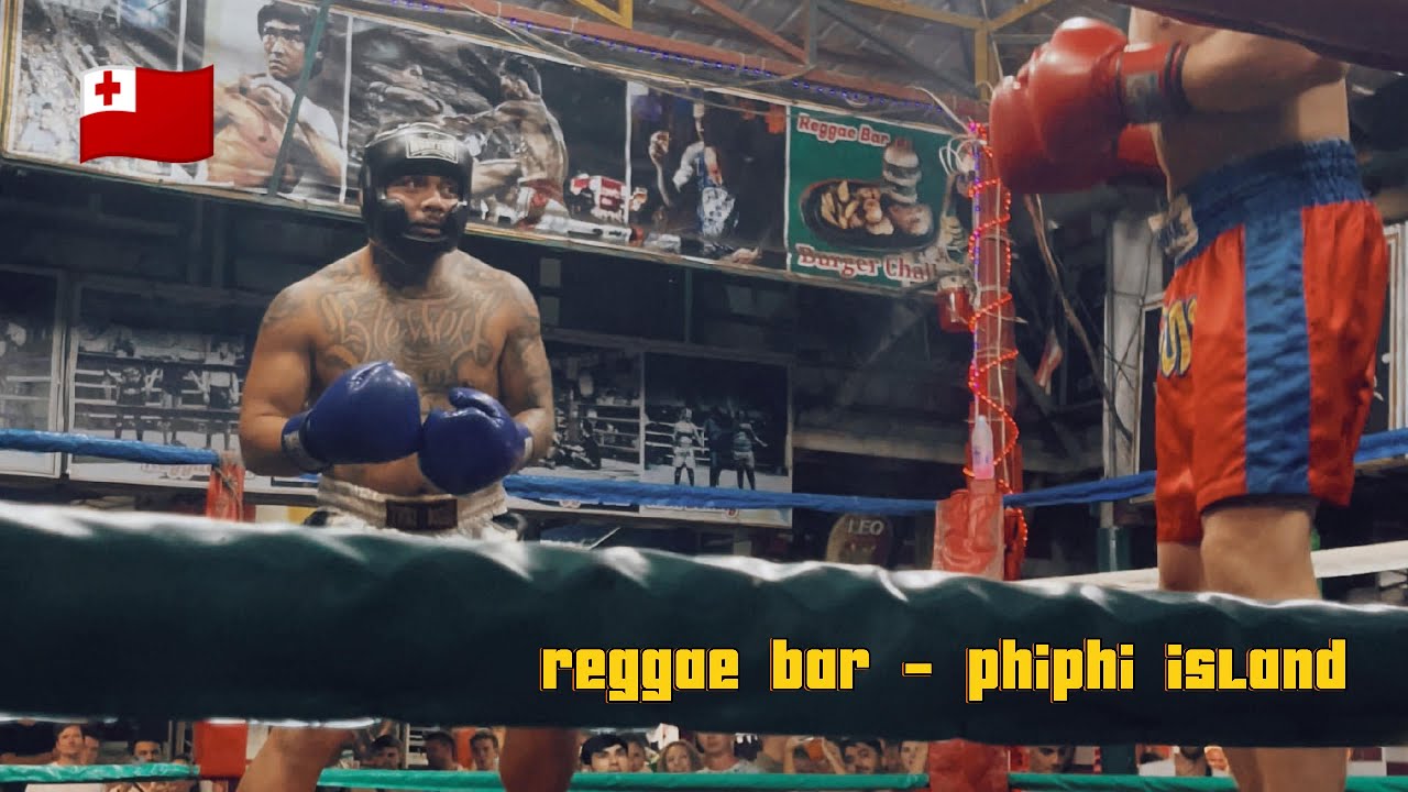A traveler participates in boxing match at Reggae Bar.