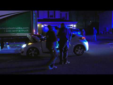 Man taken into custody after crashing car into truck