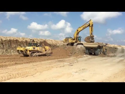 Komatsu PC 650 excavator loading HM300 and HM400 trucks D155 Dozer