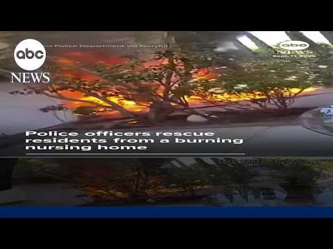 Police officers rescue residents from a burning nursing home