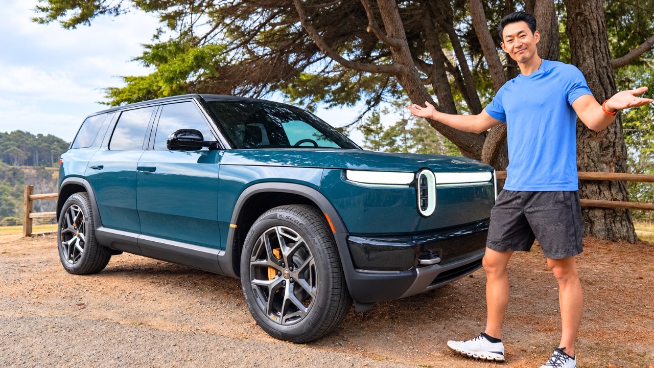 Rivian R2 charging at a Tesla Supercharger on a road trip