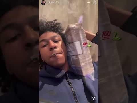 UK Rapper DigDat chilling with some serious stacks while blazing on a blunt, Or wasting a blunt! LOL