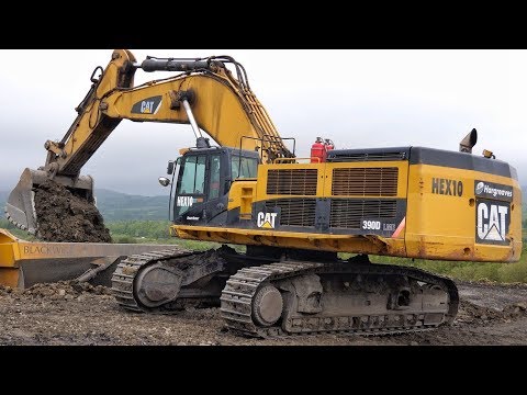 Cat 390D Excavator Loading Trucks.