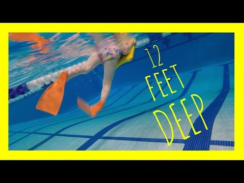 Elizabeth dives down 12 feet (3.7 meters) to pick up the red torpedo. Watch her use the kick board.
