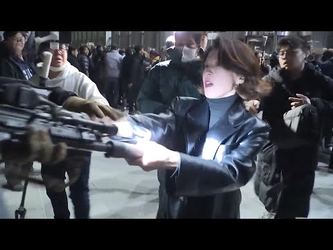 Defiant woman grabs South Korean soldier's gun during protests against martial law