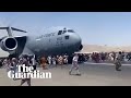 Afghans climb on to plane during takeoff in attempt to flee Taliban