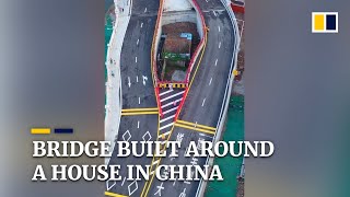 Chinese city builds bridge around house after owner refuses to move