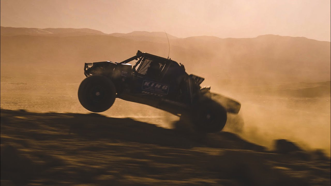 Off-road race truck airborne in desert dust at the King of the Hammers race