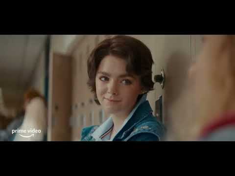 Trailer frame with Gretchen possessed, eyes hollow, under harsh school bathroom lighting