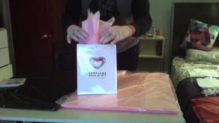 How to properly stuff tissue paper into a gift bag for a corporate event.